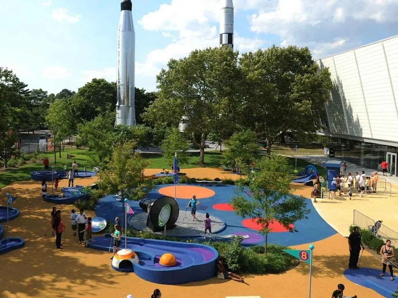 Children exploring hands-on physics exhibits at the New York Hall of Science, a science museum in New York